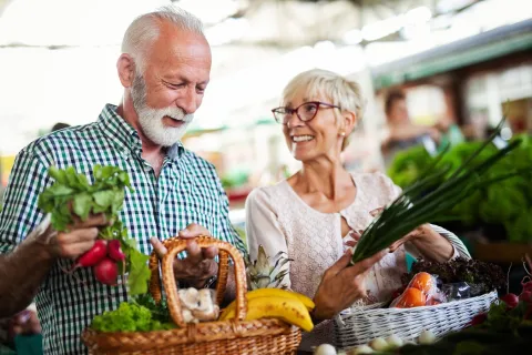 Couple agé avec un panier de fruits et légumes - De la terre à l'assiette